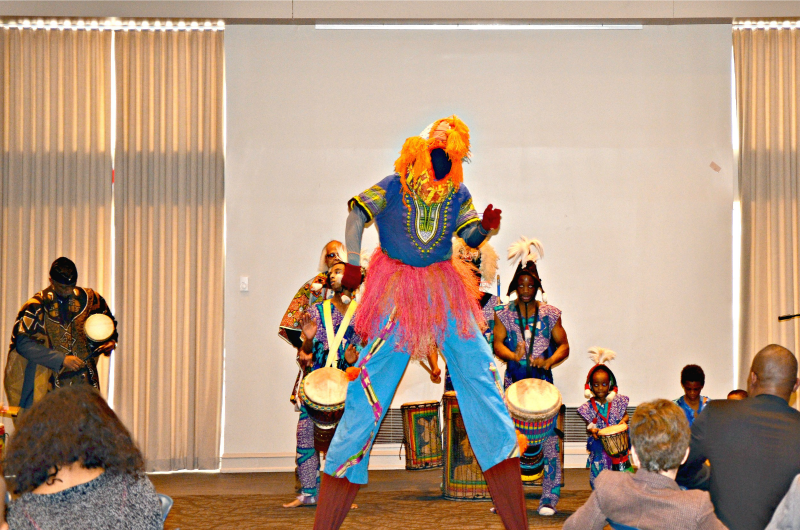 A faceless stilt-walker performs with the Universal African Drum and Dance Ensemble.